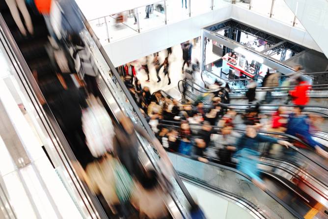 Shoppers on escalators in a mall