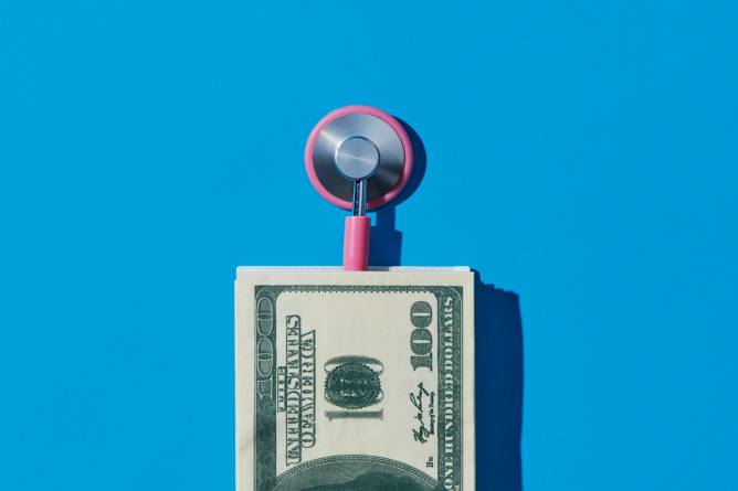 A stethoscope and hundred dollar bills