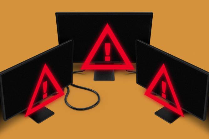 Black computer screens with red warning signs 