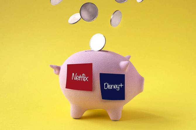 a piggy bank with Netflix and Disney+ Post-it notes on it