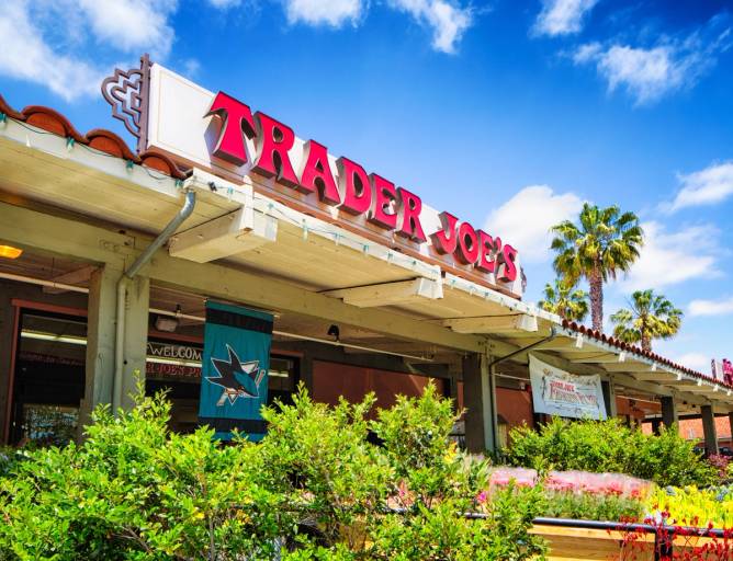 A Trader Joe's sign along the roofline of a store. 