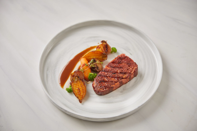 image of a 3D printed steak from Redefine Meat, plated with a side of vegetables