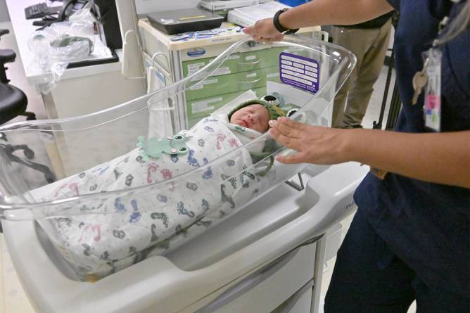 A newborn baby in a maternity ward