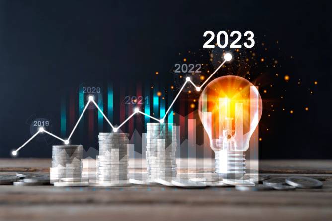 a moving graph with years under the line, going straight up over a light bulb for 2023