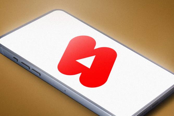 A red YouTube Shorts logo on a phone with a white background 