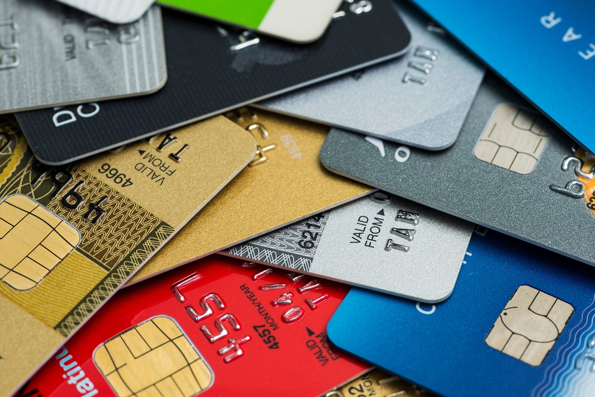 Pile of credit cards in multiple colors and brands.