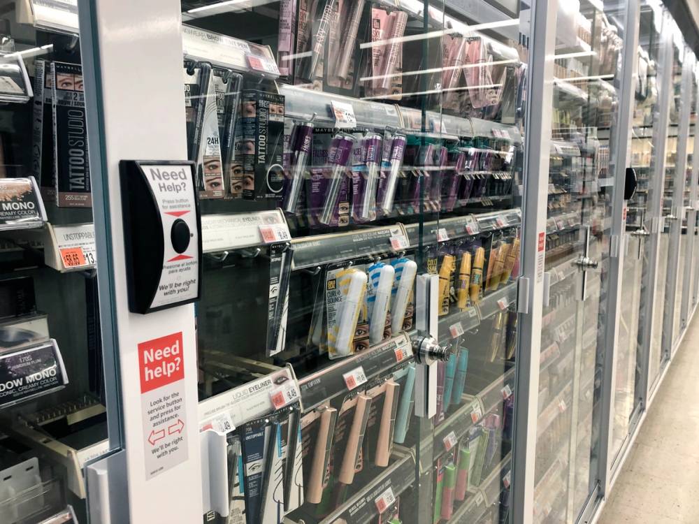 Anti-theft locked beauty products with customer service button at Walgreens pharmacy, Queens, New York