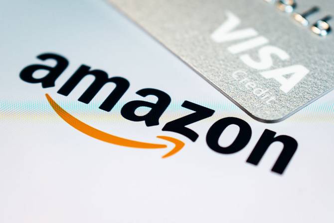 Amazon's logo next to a Visa credit card
