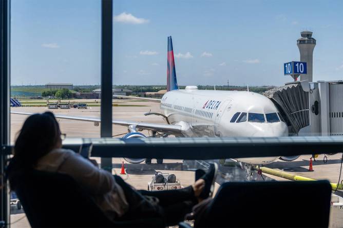 Photo from the inside of an airport looking out at a plane