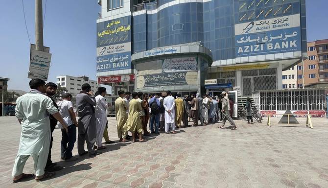 KABUL, AFGHANISTAN 15: Afghan people line up outside AZIZI Bank to take ...