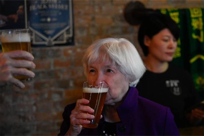 Janet Yellen drinking a beer in China