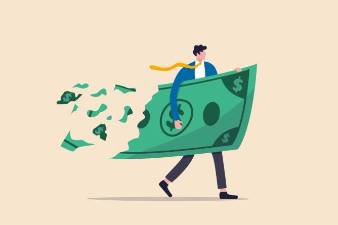 Man carrying a big piece of money that's disintegrating behind him 