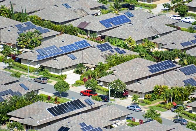 overhead image of suburban neighborhood with lots of rooftop solar panels