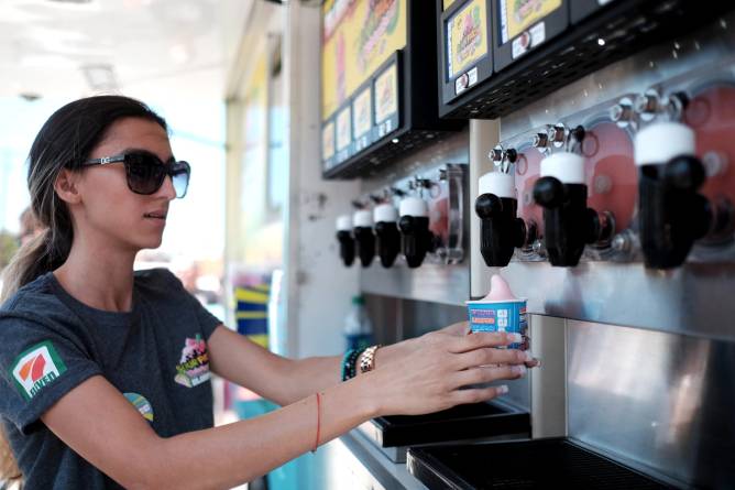 a woman at a slurpee machine