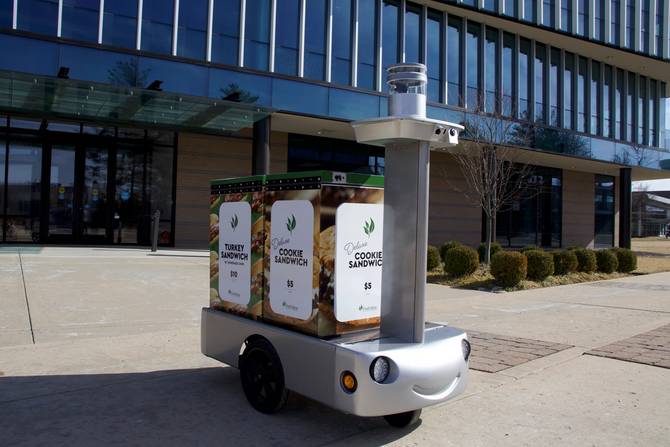 A Tortoise robot carrying tap-to-pay vending machines