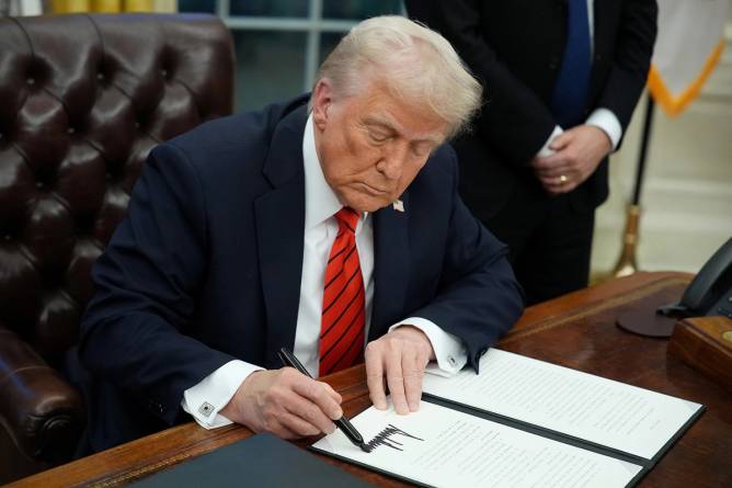 U.S. President Donald Trump signs a series of executive orders in the Oval Office