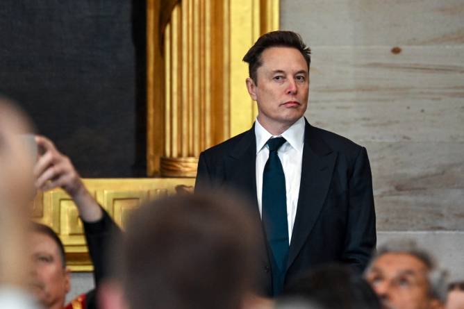 elon musk standing alone at inauguration