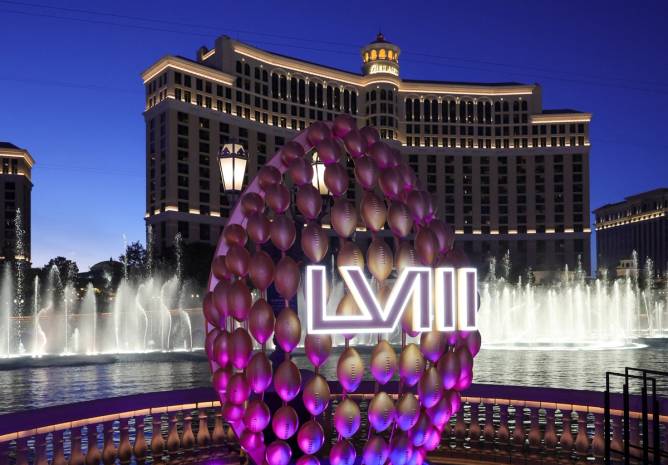 The Fountains of Bellagio launch behind a display of footballs with a Super Bowl LVIII logo on the CBS Sports set being built for the game in front of Bellagio Resort & Casino on February 03, 2024 in Las Vegas, Nevada.