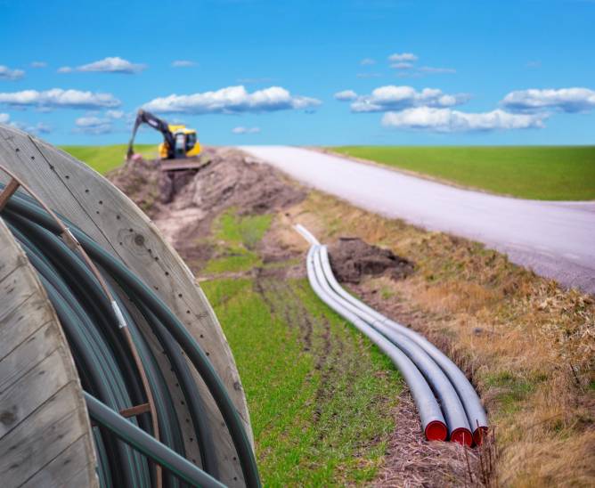 Image of broadband cables being laid on a rural road.