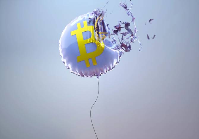 A balloon with the bitcoin symbol pops 