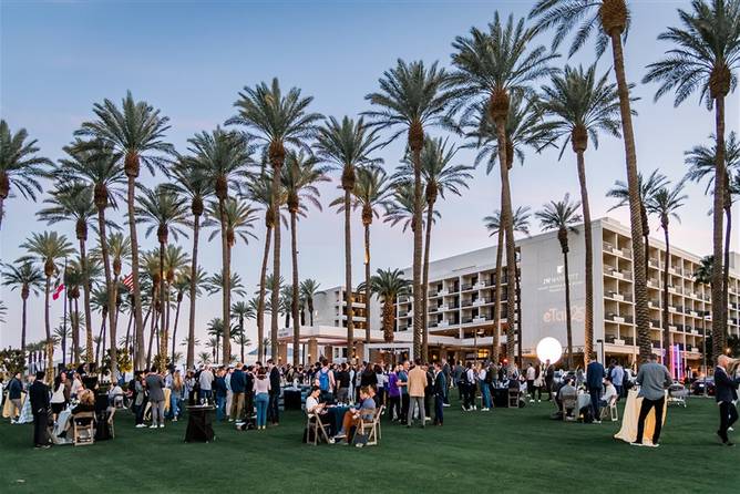 People gathered on the lawn outside a hotel at eTail West.