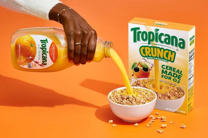 A photo of Tropicana orange juice being poured over a bowl of Tropicana Crunch cereal, which is intended to be eaten with OJ, not milk. 