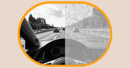 Closeup of a person’s windshield looking out onto a highway with the left half of the vision normal and the right side displaying Visual Snow Syndrome