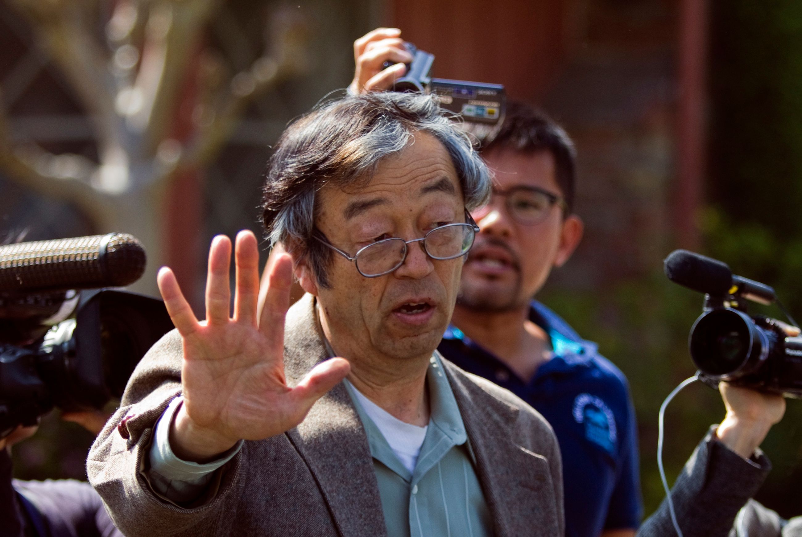 Satoshi Nakamoto, Older asian man in suit, disheveled appearance.