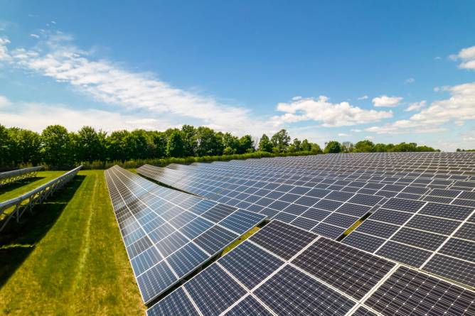 Solar panels in a green field.