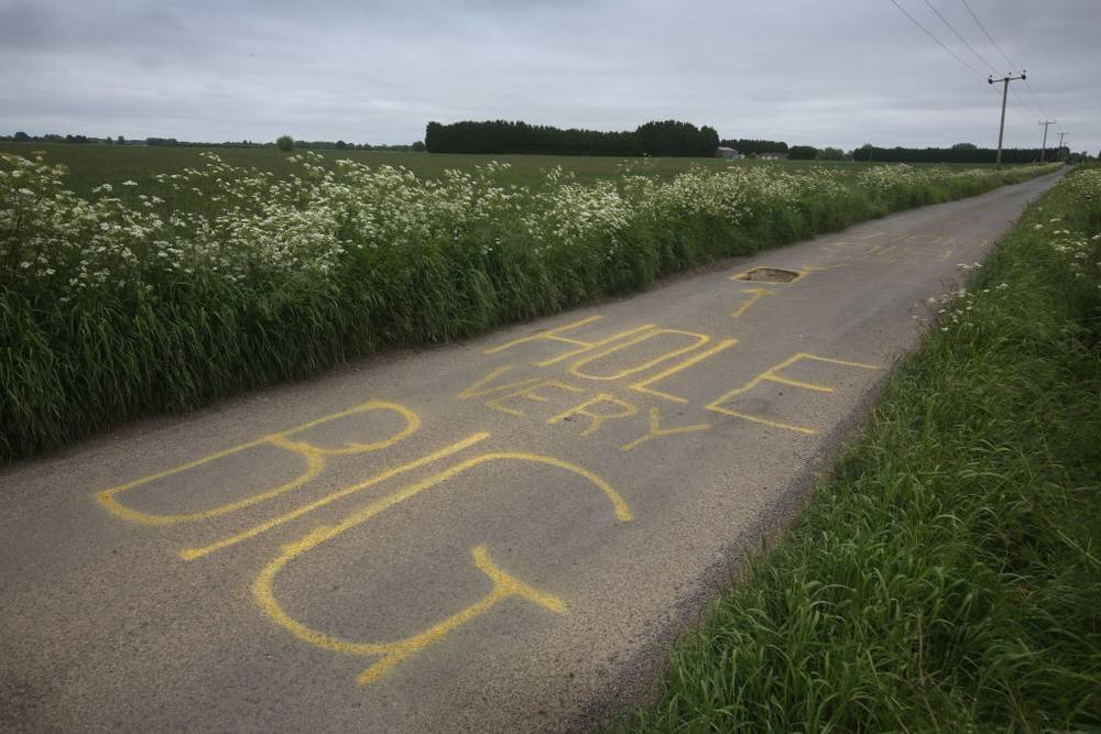A huge pot hole in Murrow Lane has been marked with a large warning message in yellow paint, saying 'Hole Very Big'