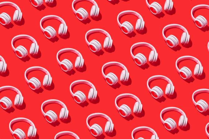 a pattern of white headphones on a red background