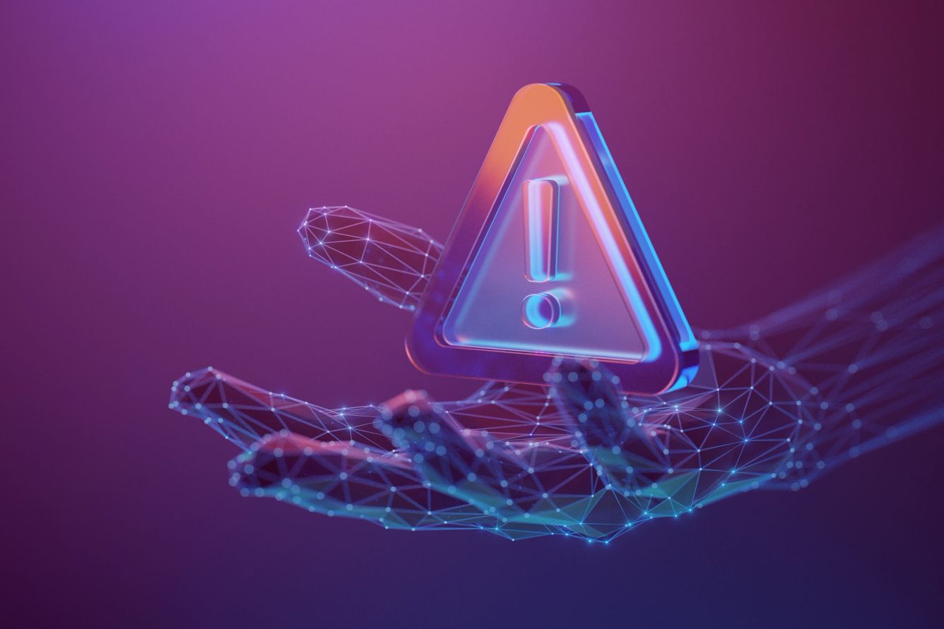 A warning symbol in a cyber-looking hand