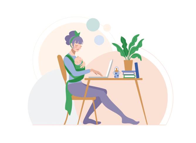 Mom with baby works at desk.