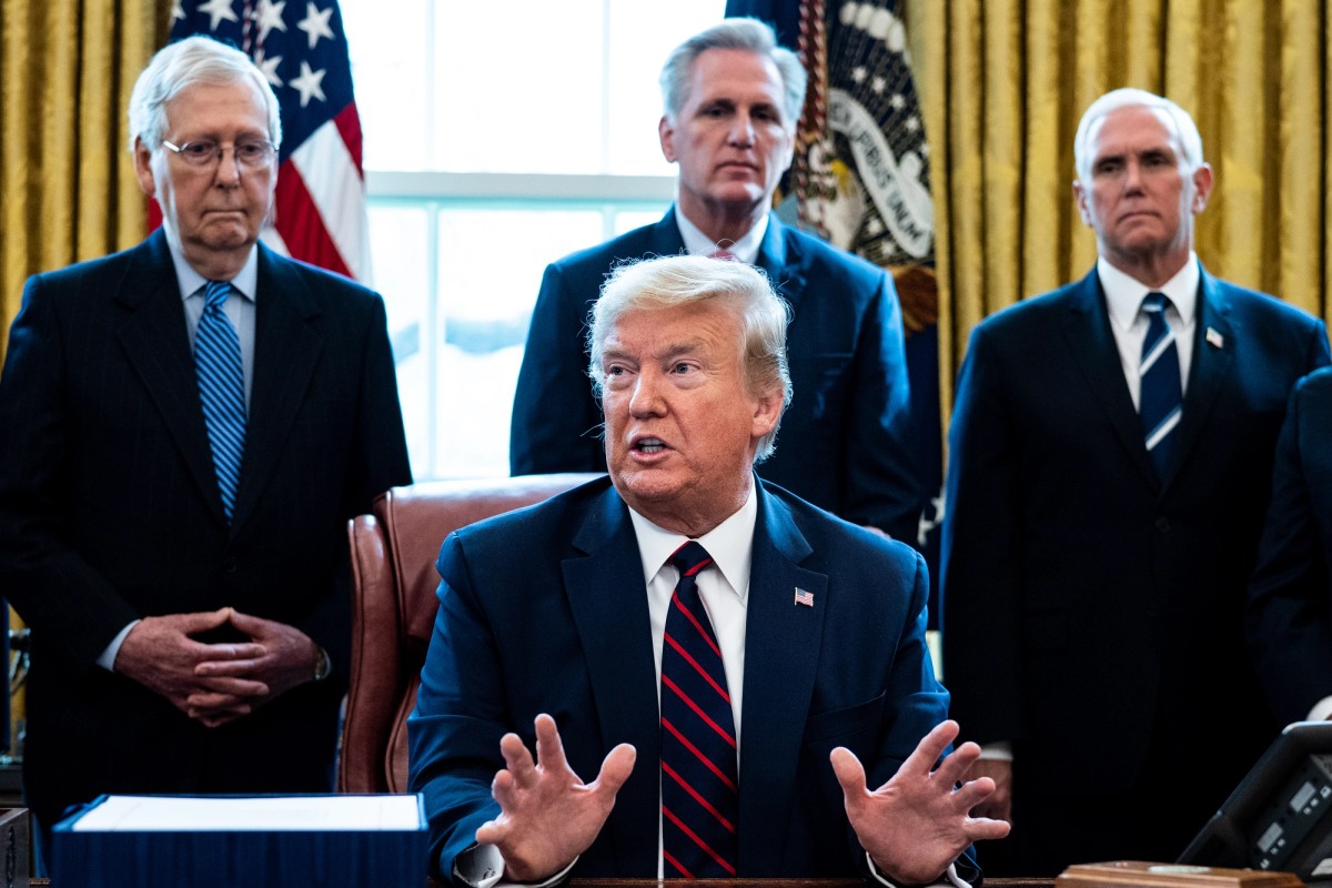 U.S. President Donald Trump speaks while he signs H.R. 748, the CARES Act in the Oval Office of the White House on March 27, 2020