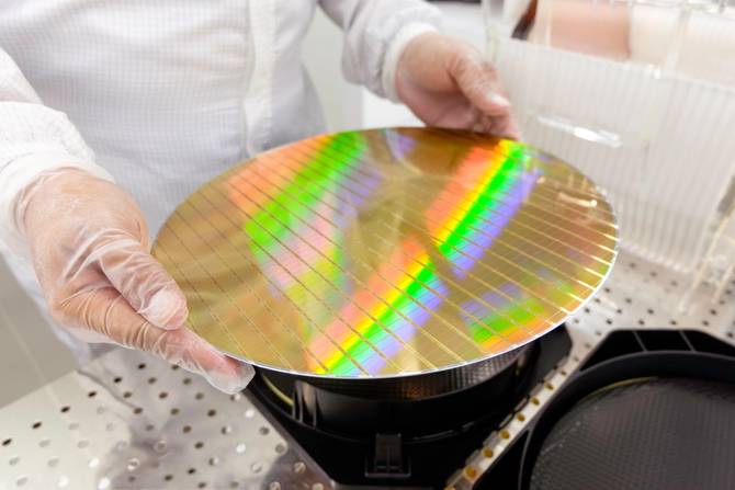 person holding a silicon wafer