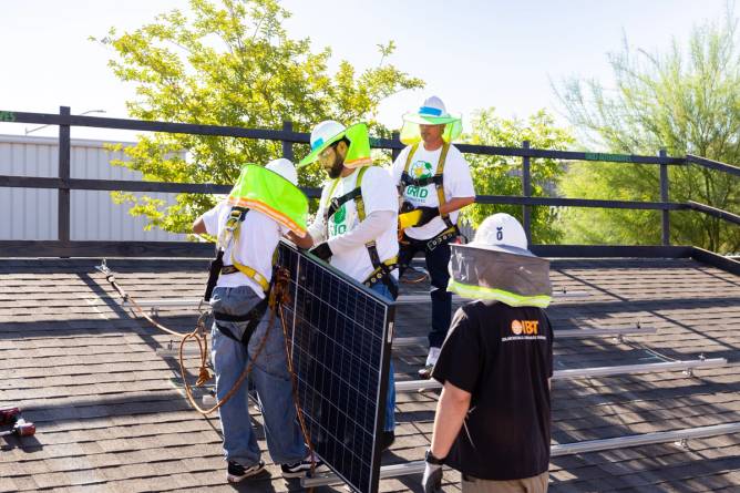 GRID Alternatives workers installing solar panels.