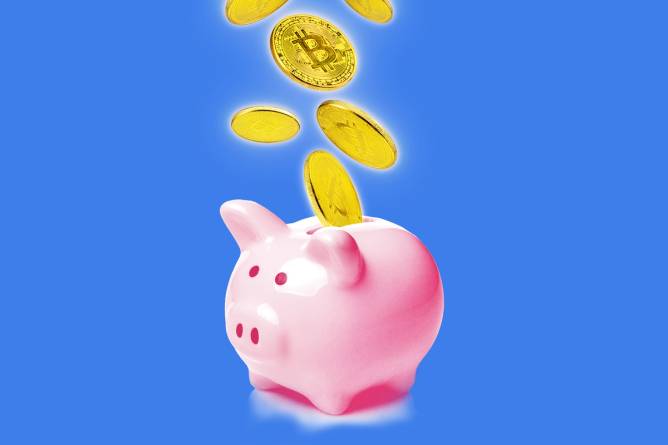 Coins, including a Bitcoin, fall into a piggy bank.