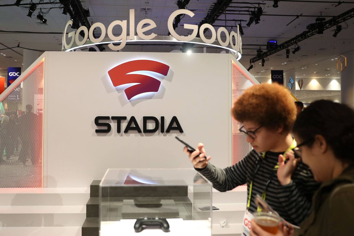 Attendees look at the new Stadia controller on display at the Google booth at the 2019 GDC Game Developers Conference.