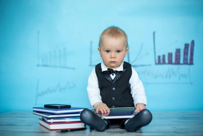 toddler dressed in suit with books