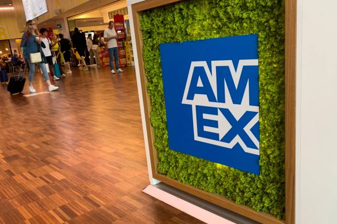 the AmEx logo appears on a sign