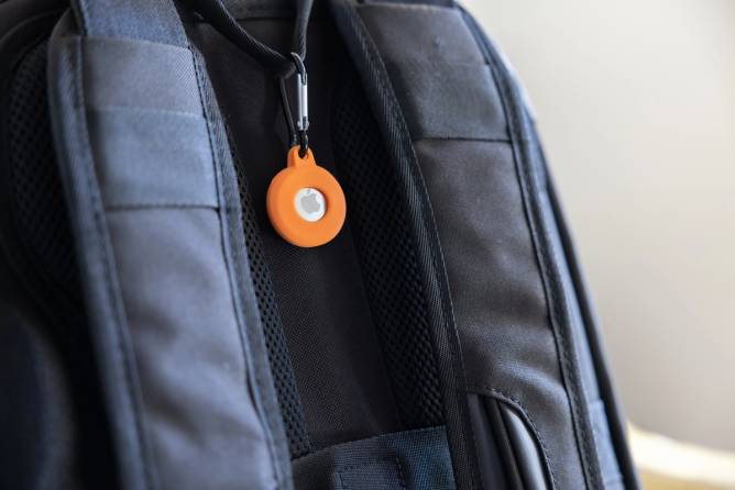 An Apple AirTag tied to a backpack