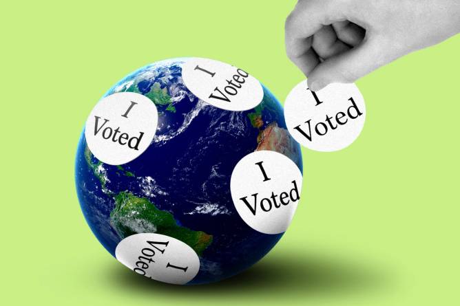 A globe covered in "I voted" stickers