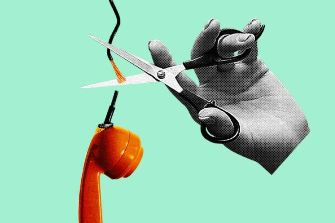 Hand with a scissor cutting a telephone landline.