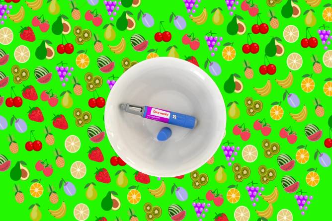 A semiglutide pen in a bowl surrounded by fruit