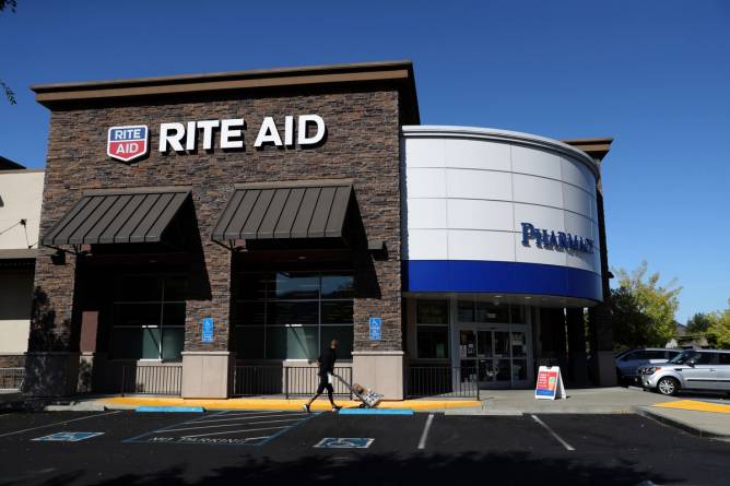 A Rite Aid store viewed from a parking lot.