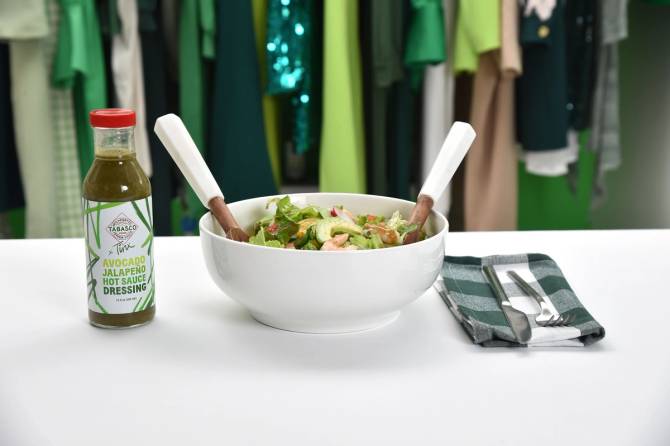 a salad bowl with Tabasco salad dressing next to it