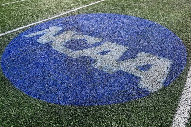 The NCAA logo on a football field