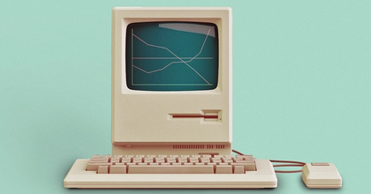 A retro computer with a mouse and keyboard displaying a line graph on the screen on a light teal background