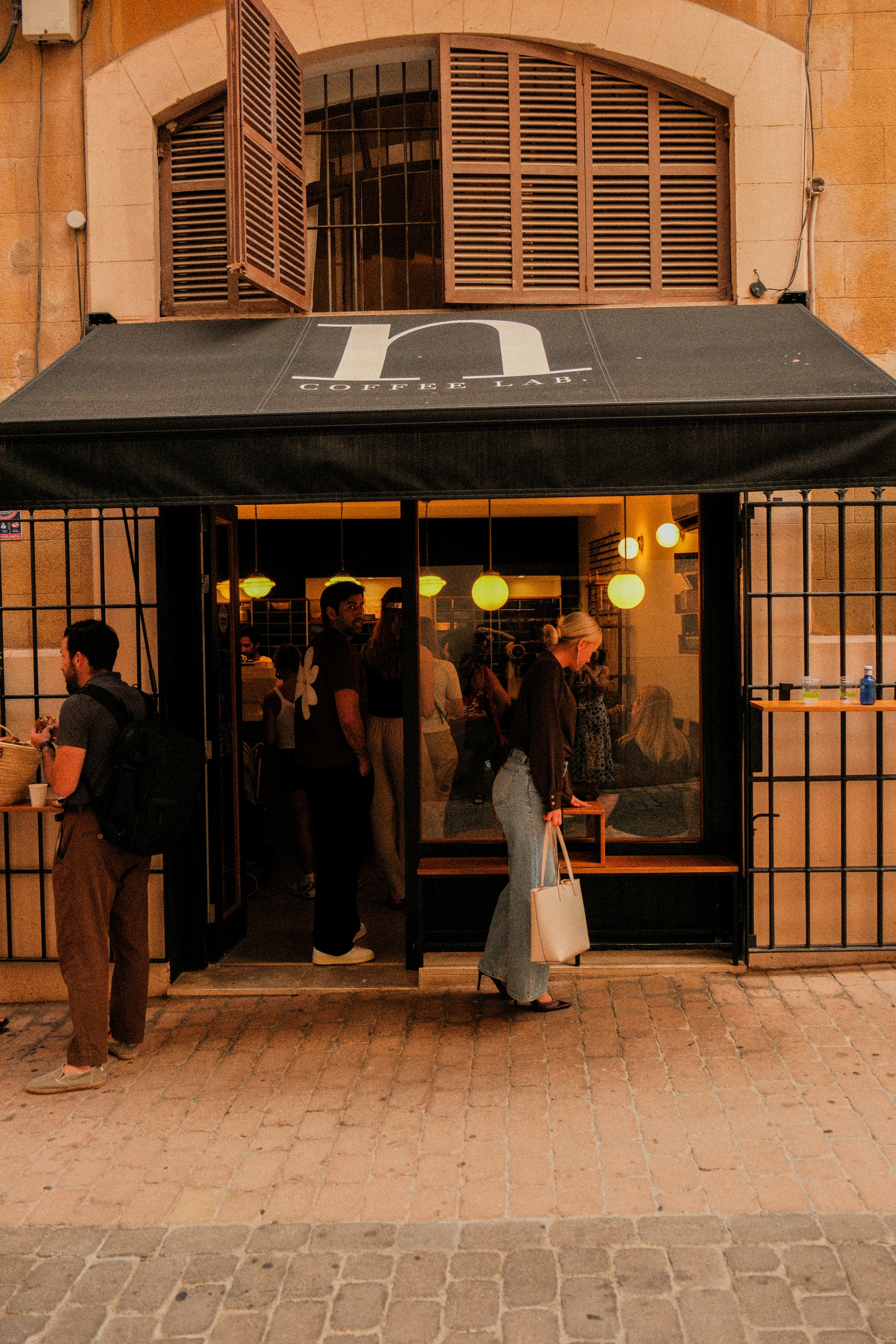 Retail storefront event with crowd.