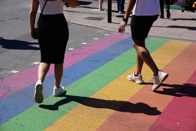JUNE 01: People walking over a rainbow crossing 